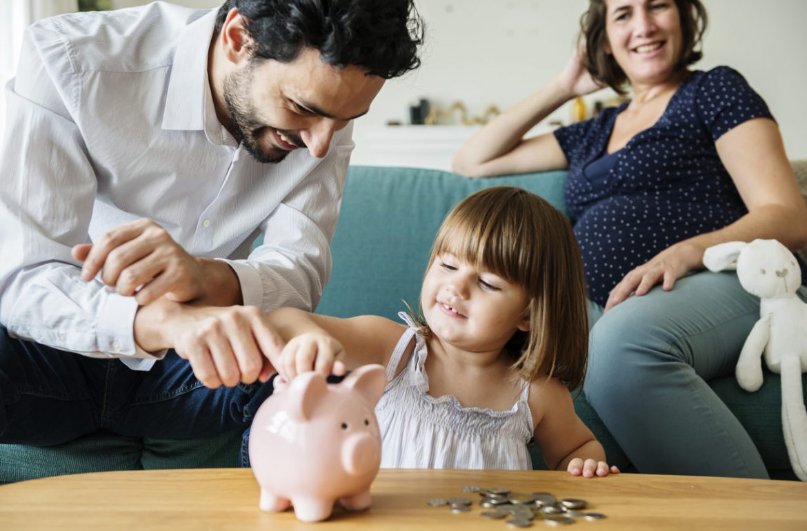 Family saving money in piggy bank